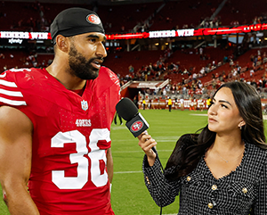 Lindsey-Pallares-363-241 Lindsey Pallares, right, interviewing Curtis Robinson on football field