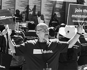 Voting+awareness+363-241 A man from the organization Time Done holds up a sign that reads ‘Join the Movement.’