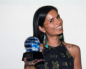 nina-gualinga-363-241 Nina Gualinga smiling and holding trophy