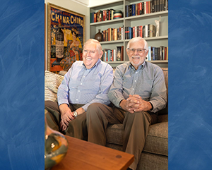 BOHNE BYE – Q&A – 363 – 241 An image of Tom Bye (left) and David Bohne (right) sitting in a room with books and posters superimposed over a blue background.