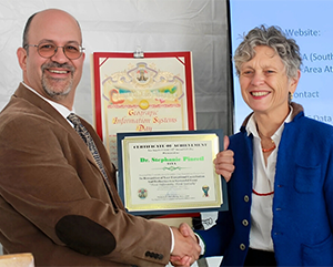 Pincetl-GIS-Award-363-241 Steven Steinberg, L.A. County’s Geographic Information Officer, presents Pincetl with an award at the county’s 17th annual GIS Day.
