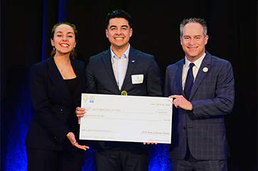 From left: Noor Nakhaei, president of UCLA’s Graduate Student Association; 2025 UCLA Grad Slam champion Pablo Alvarez; Brian Kite, UCLA dean and vice provost of graduate education.