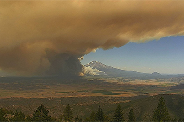 2021 Tennant Fire smoke rises in front of a mountain in Yreka, Calif.