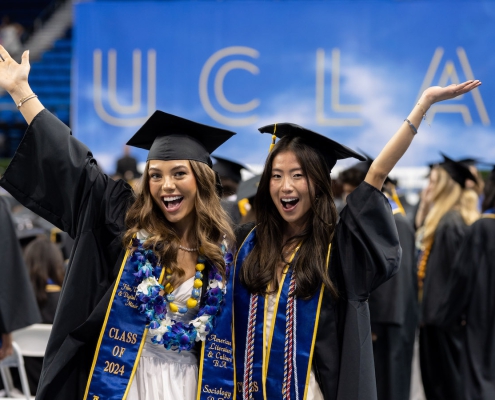 Two newly minted graduates pose for the camera
