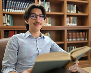Eric-Sican-in-Grace-M-Hunt-Reading-Room-by-Sean-Brenner-UCLA-Humanities-363-241 Eric Sican seated in leather chair with bookshelves behind him