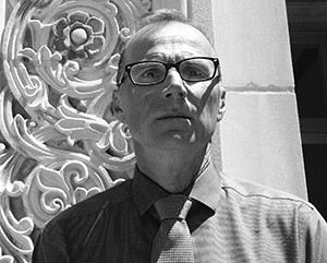 Robert Gurval Dodd Hall portrait courtesy of Robert Gurval – 363 – 241 Black and white photo of Robert Gurval in front of a UCLA campus building