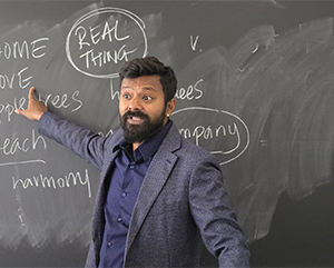 Vetri-Nathan-at-chalkboard-global-food-studies-363-241 Vetri Nathan pointing at words on a chalkboard while teaching global food studies class