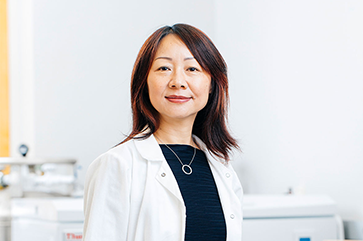 Dr. Lili Yang in a white lab coat.