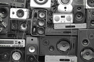 A black and white image of a wall of speakers