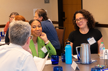 From left: David Myers (back turned); Brenda Suttonwills, DaD faculty fellow and assistant dean for diversity, equity and inclusion initiatives at UCLA Law; and Ralina Joseph, vice provost for inclusive excellence, share a moment at the celebration honoring the first cohort of DaD faculty fellows.