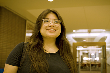 Head-and-shoulderss photo of Evelyn Giron in black top and glasses