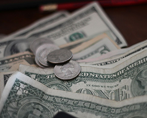 mathieu-turle-363-241 A few coins on top of several one dollar bills