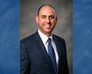 UCLA Police Chief Craig Valenzuela portrait in blue suit and blue tie