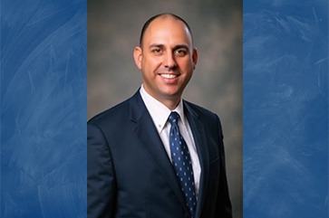 UCLA Police Chief Craig Valenzuela portrait in blue suit and blue tie
