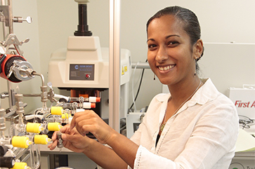 Aradhna Tripati in a white shirt, smiling inside of a lab setting.