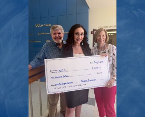 Three people holding a giant check.