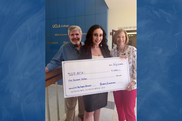 Three people holding a giant check.