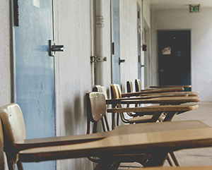 giorgio-trovato-FDYApgCf_rY-unsplash_a1ee83ca-b99f-42d4-8b89-12f79f934cc0-prv-363-241 A row of empty school desks