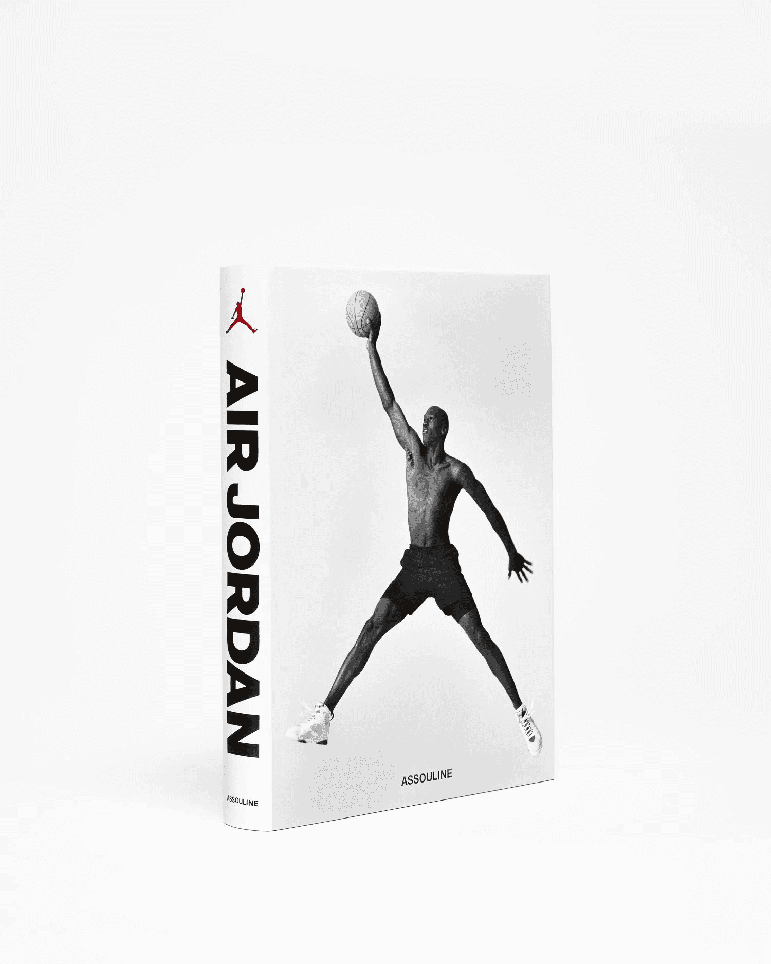 A book titled Air Jordan by Assouline, featuring a black-and-white cover photo of a man in athletic gear jumping and holding a basketball with one hand outstretched.