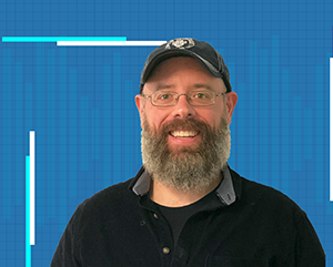 Eric Deeds in a black shirt against a blue grid background