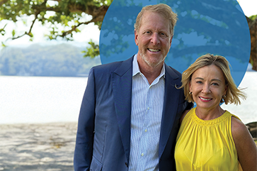 Barry Eggers, left, in blue jacket and striped button-down, standing next to Meredith Eggers, in yellow top