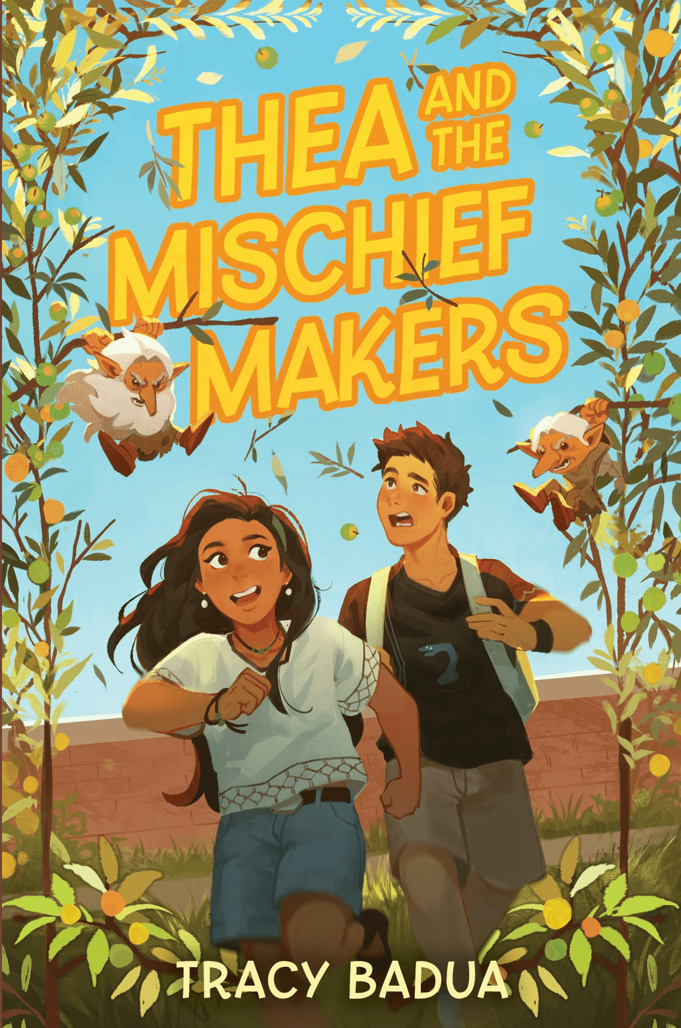 Two children run through a leafy archway, smiling and looking back as two winged monkeys fly overhead. The book title Thea and the Mischief Makers is in bold yellow letters above them. The author is Tracy Badua.